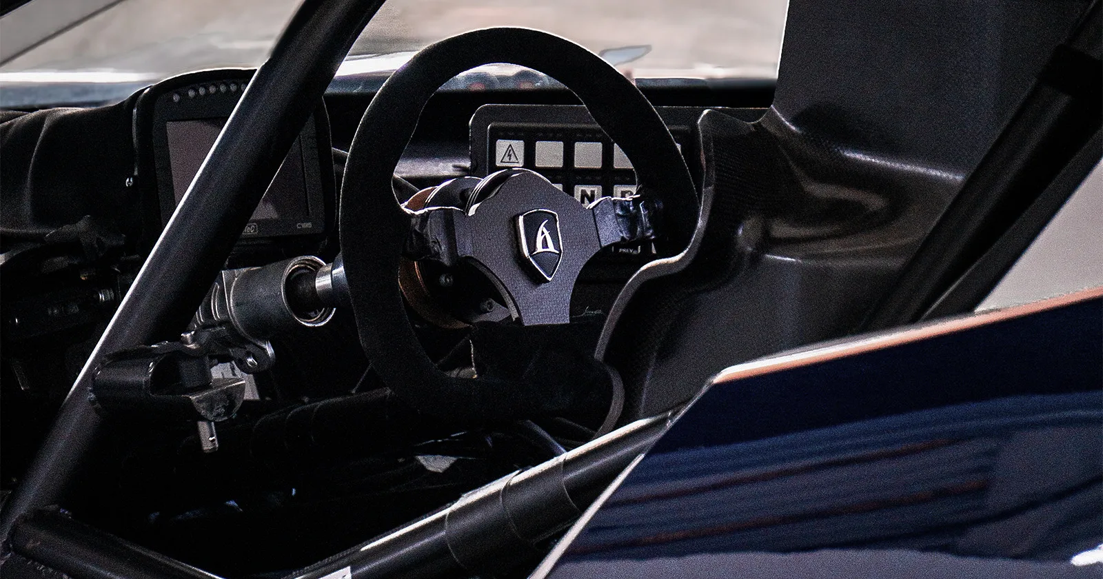Aspark SP600 – cabin close-up with steering wheel and driver seat