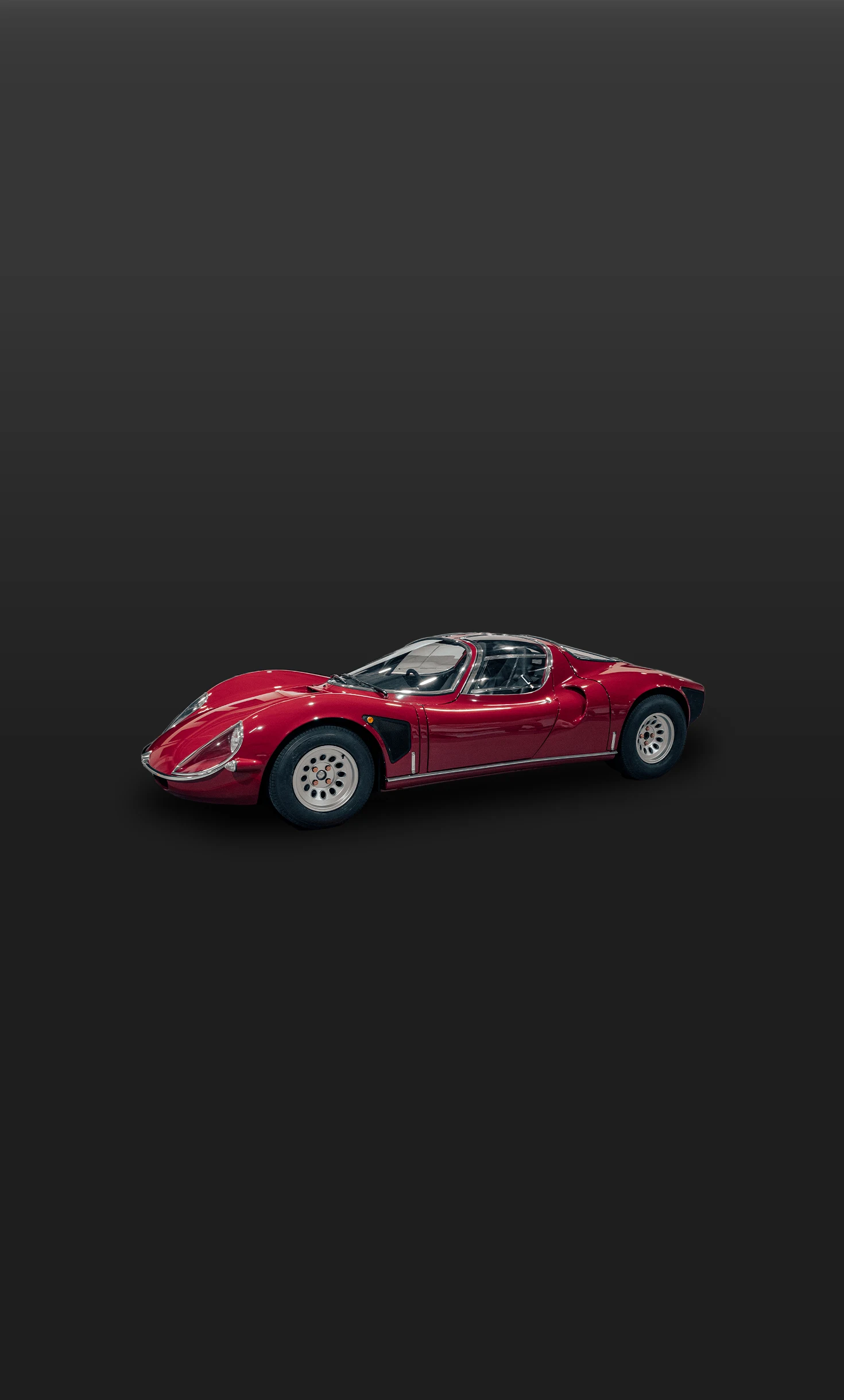 Lateral side view of the Jewelry by Manifattura Automobili Torino against a dark gradient background, showcasing its bespoke design and sculpted proportions