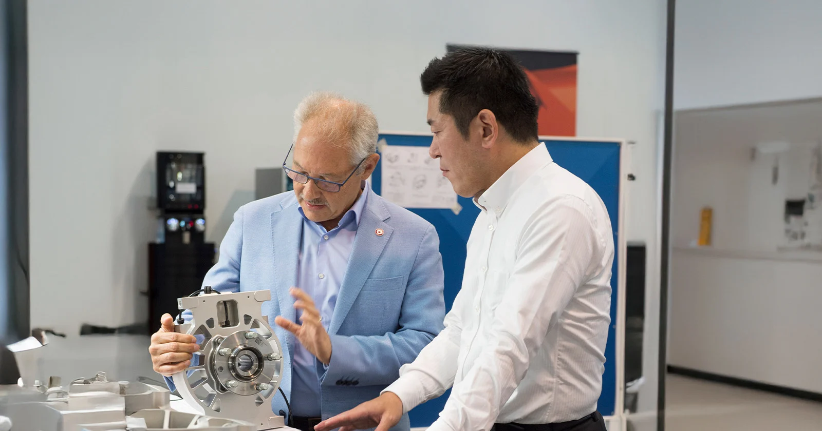 Paolo Garella and Masanori Yoshida examining car component
