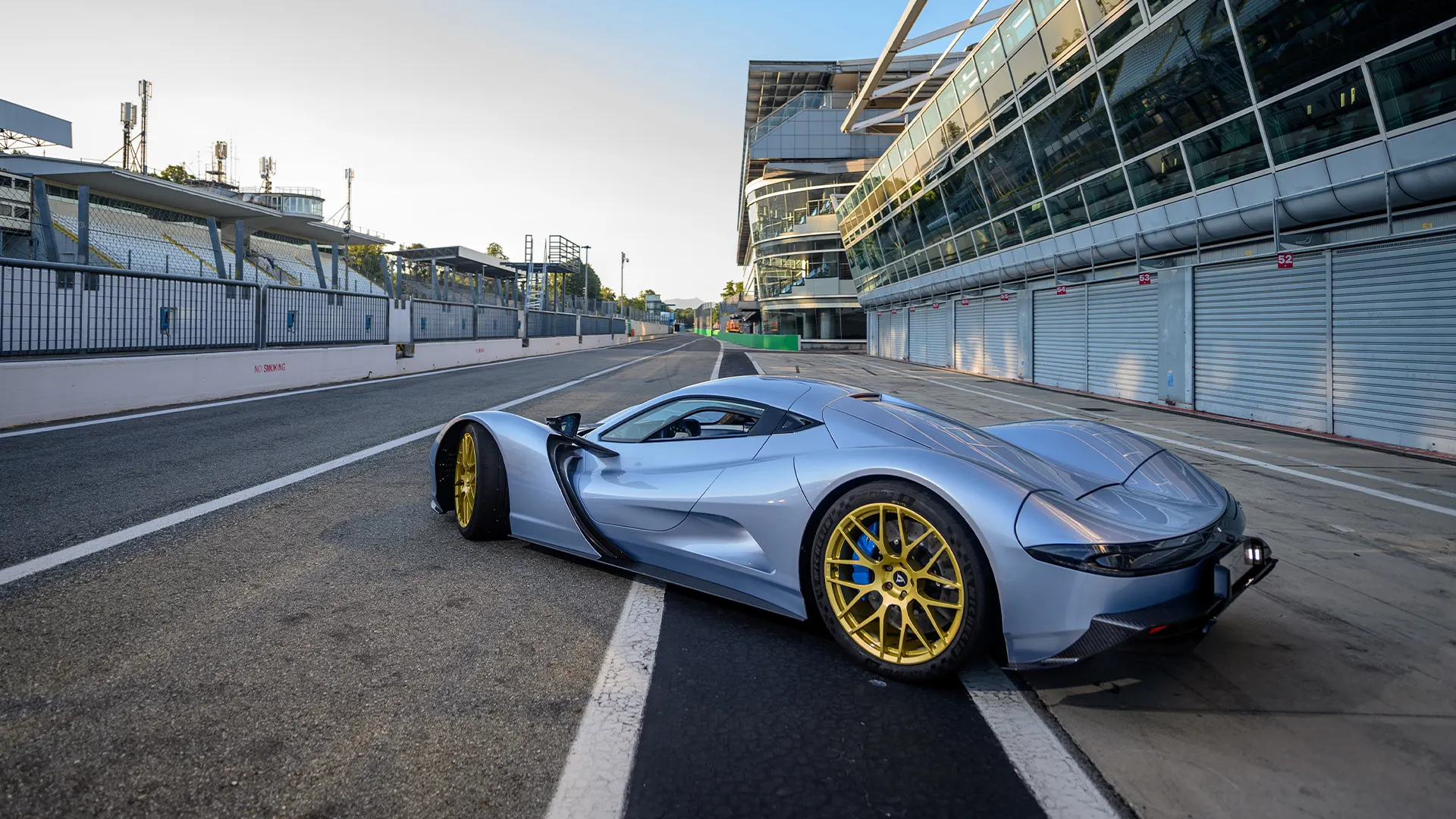 Rear view of the Aspark Owl parked on a race track