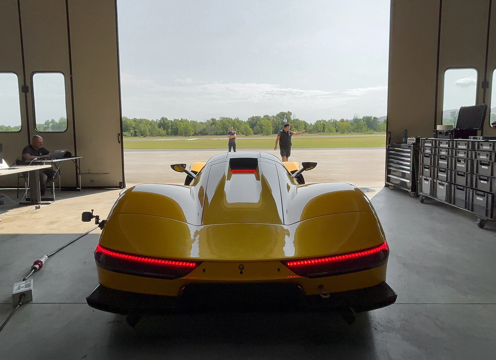 Aspark Owl Roadster – rear side view exiting garage