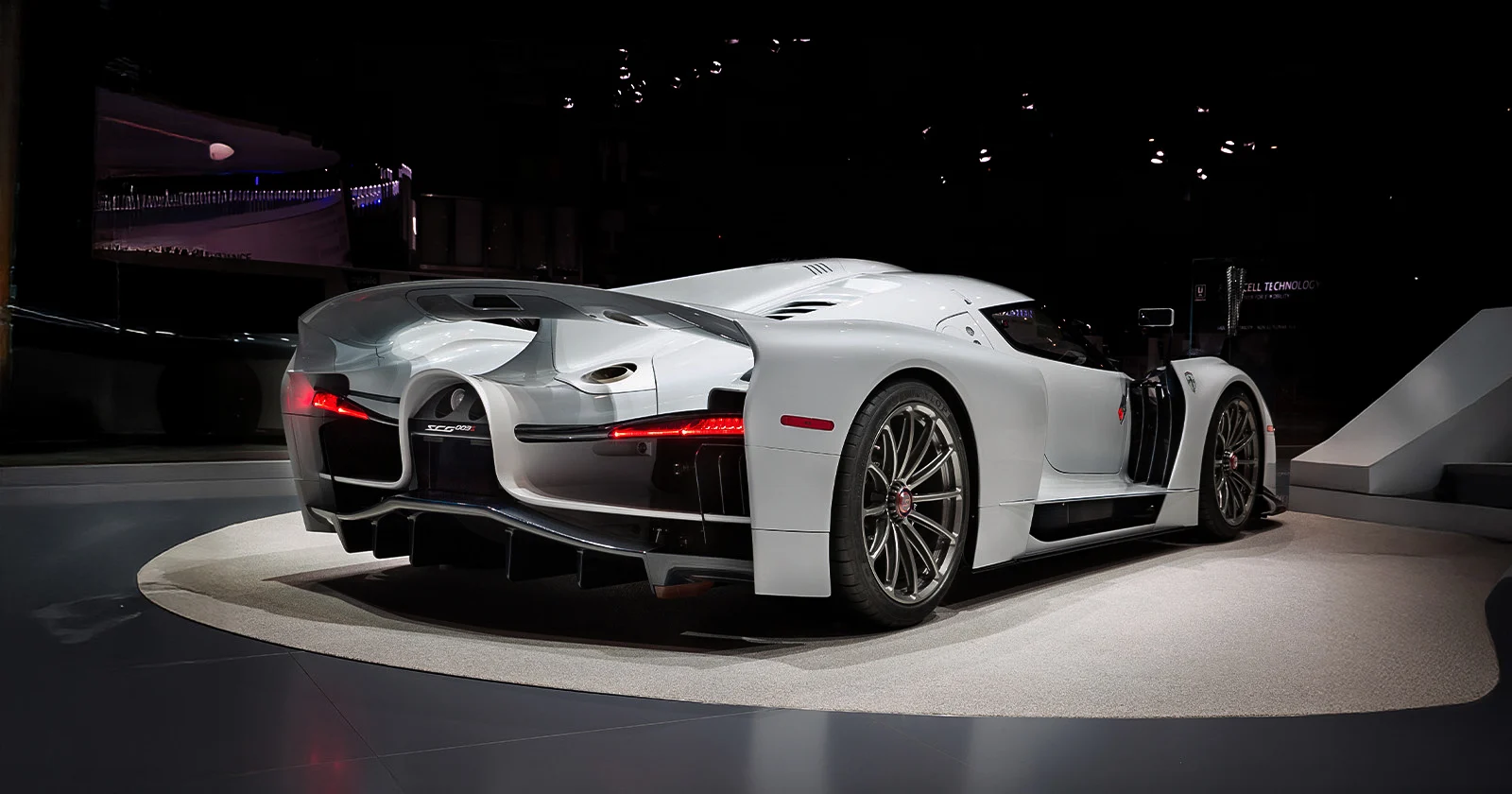SCG003S – Three-Quarter Rear Side View at an Auto Show | Manifattura Automobili Torino